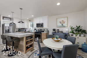 Dining space featuring light wood-style floors and recessed lighting