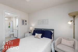 Bedroom with ensuite bathroom and wood finished floors