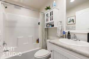 Bathroom featuring shower / bath combo and vanity