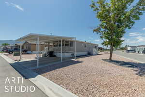 View of front of house with covered porch and an attached carport