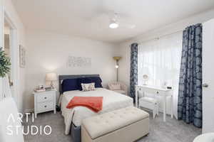 Carpeted bedroom with a ceiling fan