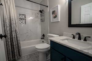 Full bath featuring shower / bath combination with curtain and vanity
