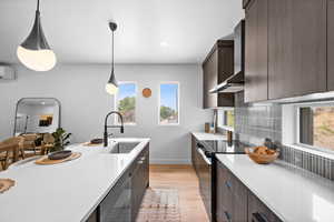 Kitchen with dark brown cabinetry, modern cabinets, black range with electric stovetop, plenty of natural light, and recessed lighting