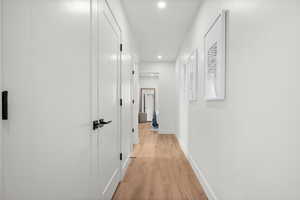 Hall with recessed lighting and light wood finished floors