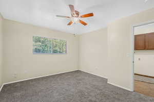 Primary bedroom upstairs with new carpet featuring a ceiling fan