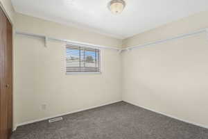 Second bedroom upstairs featuring new carpet