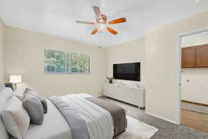 Carpeted bedroom with baseboards and a ceiling fan *Virtually Staged*