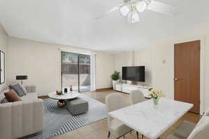 Living room with tile patterned floors and baseboards *Virtually Staged*