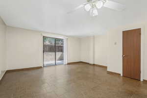Living room featuring tile flooring, half bathroom behind door to the right