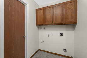 Laundry room upstairs with electric dryer hookup, cabinet space, washer hookup, hookup for an electric dryer, full bathroom located behind the door to the left.