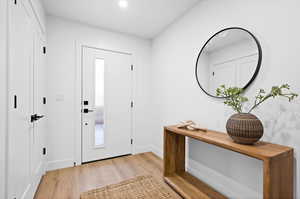 Foyer entrance featuring light wood-style flooring and recessed lighting