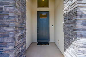 Doorway to property with stone siding