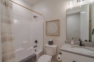 Full bathroom with shower / bathtub combination with curtain and vanity