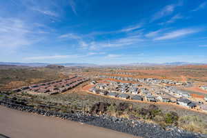 Aerial overview of property's location featuring a mountainous background and nearby suburban area