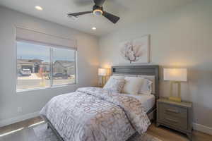 Bedroom with wood finished floors, a ceiling fan, and recessed lighting