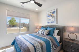 Bedroom with wood finished floors, ceiling fan, and recessed lighting