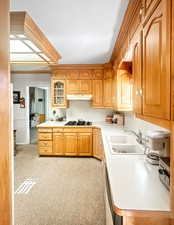 Kitchen featuring light countertops, glass insert cabinets.