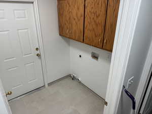 Laundry area with cabinet space, washer hookup, and hookup for an electric dryer