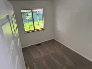 Unfurnished room featuring carpet and baseboards