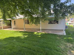 Back of house with a patio area