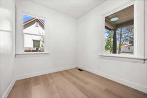 Unfurnished room featuring baseboards and light wood-type flooring