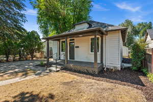 Bungalow-style home with covered porch and roof with shingles