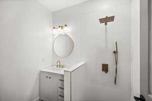 Bathroom with vanity and tiled shower