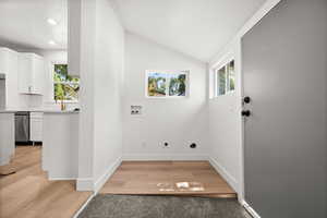Washroom featuring washer hookup, light wood-style flooring, and hookup for an electric dryer