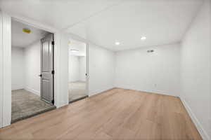 Empty room featuring light wood-style flooring and recessed lighting