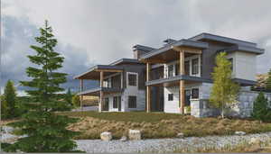 View of front of property featuring stone siding and a balcony