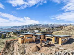 Rear view of property featuring a mountain view and a patio