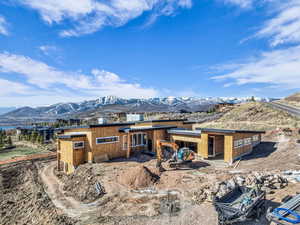 Rear view of house with a mountain view and a patio area