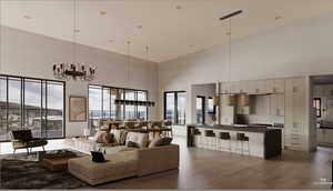Living room featuring a high ceiling, a chandelier, and light wood-type flooring