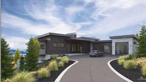 View of front facade featuring an attached garage and driveway