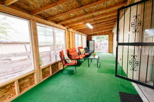 Sunroom / solarium featuring vaulted ceiling