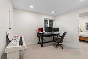 Office area with light colored carpet, recessed lighting, and electric panel