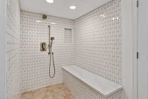 Full bath with a tile shower, tile patterned floors, and recessed lighting