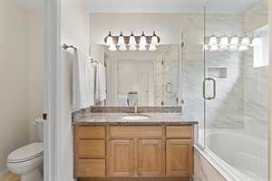 Full bathroom featuring vanity and enclosed tub / shower combo
