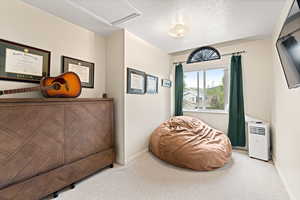 Sitting room with carpet flooring and baseboards
