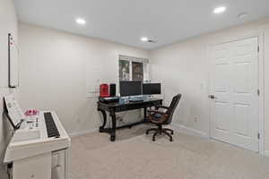 Home office featuring light carpet, recessed lighting, and electric panel