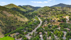 Aerial view of property's location featuring a mountain backdrop and nearby suburban area