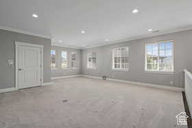 Carpeted spare room with ornamental molding and recessed lighting