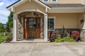Doorway to property featuring stone siding