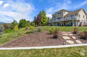View of green lawn featuring stairs