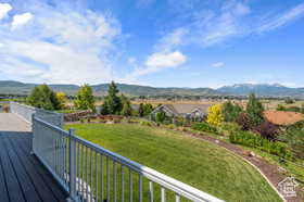 Wooden terrace with a lawn and a mountain view