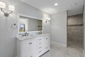 Lower level primary bathroom, walk-in shower, double vanity, private commode, recessed lighting