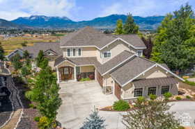 View of front of home featuring concrete driveway and a mountain view