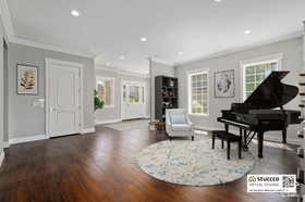 Sitting room featuring crown molding, recessed lighting, and dark wood-style flooring