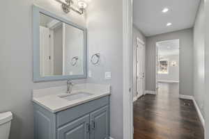 Half bathroom near entry and garage, vanity, recessed lighting,