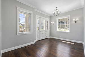 Entryway, natural light, chandelier  lighting,  crown molding